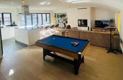 a living room with a pool table in the middle at PENTHOUSE SABLON in Brussels