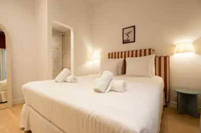 a bedroom with a large white bed with towels on it at SHWAY - The Captain's View in Antwerp
