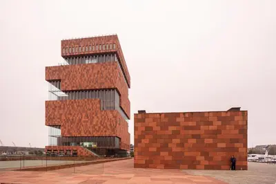a tall red brick building with a person standing next to it at SHWAY - The Captain's View in Antwerp