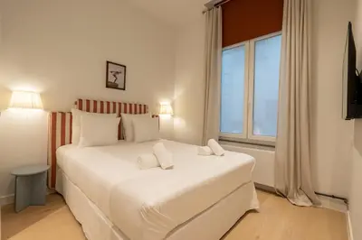 a bedroom with a large white bed with a window at SHWAY - The Captain's View in Antwerp