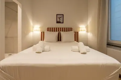 a bedroom with a large white bed with two pillows at SHWAY - The Captain's View in Antwerp