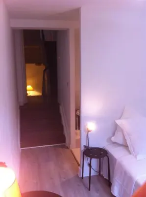 a bedroom with a bed and a staircase with a table at Hotel Residence 18 in Brussels