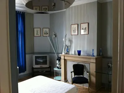 a bedroom with a bed and a fireplace and a tv at Hotel Residence 18 in Brussels