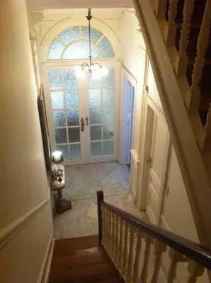 a hallway with a staircase leading to a door at Hotel Residence 18 in Brussels