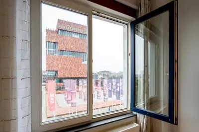 a window with a view of a building at SHWAY - The First Mate's Watch in Antwerp