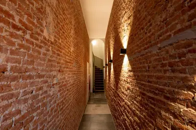 an alley with a red brick wall at SHWAY - The First Mate's Watch in Antwerp