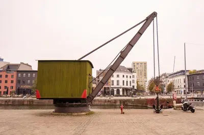 a large dumpster being lifted by a large crane at SHWAY - The First Mate's Watch in Antwerp