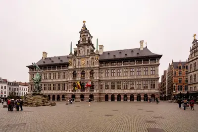 a large building with a clock tower on top of it at SHWAY - The First Mate's Watch in Antwerp