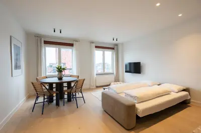 a living room with a couch and a table at SHWAY - The First Mate's Watch in Antwerp