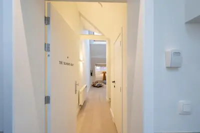 a hallway with white walls and a long corridor at SHWAY - The Seaman's Sight in Antwerp
