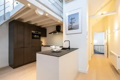 a kitchen with a white island in a room at SHWAY - The Seaman's Sight in Antwerp