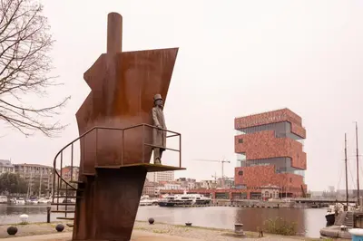 a statue of a man standing on a boat at SHWAY - The Seaman's Sight in Antwerp