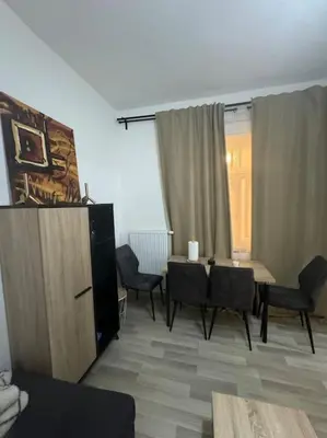 a living room with a table and chairs and a room at Appartement à Bruxelles in Brussels