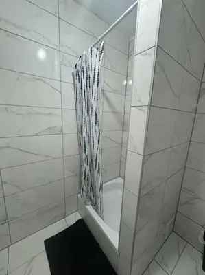 a bathroom with a shower with a shower curtain at Appartement à Bruxelles in Brussels