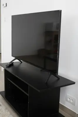 a black desk with a tv on top of it at Magnifique penthouse ERASME in Brussels