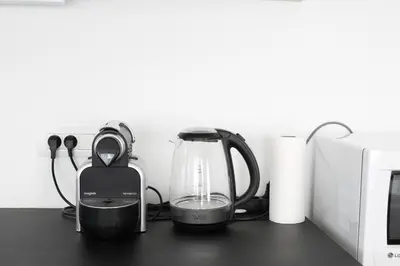 a tea kettle and a blender on a table at Magnifique penthouse ERASME in Brussels