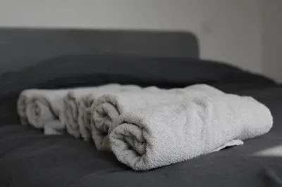 a towel sitting on top of a bed at Magnifique penthouse ERASME in Brussels