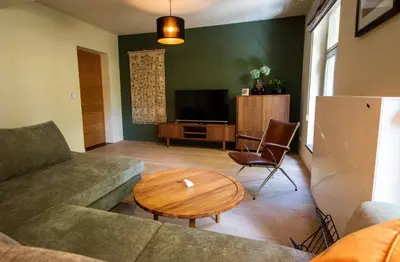 a living room with a couch and a table at Zesdrienegen in Ghent