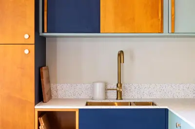 a kitchen with a sink and a blue cabinet at Zesdrienegen in Ghent
