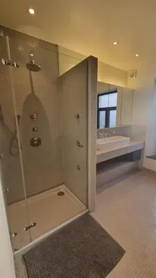a bathroom with a shower and a sink and a tub at Zesdrienegen in Ghent