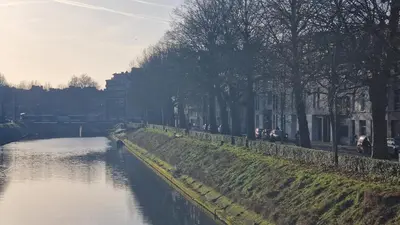 a river with trees on the side of it at Zesdrienegen in Ghent