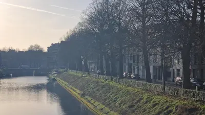 a river with trees on the side of it at Zesdrienegen in Ghent