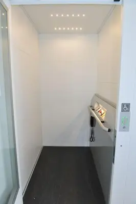 a small bathroom with a white wall and a hallway at Jeugdverblijfcentrum Schotte in Aalst