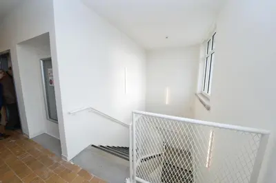 a staircase in a building with a white wall at Jeugdverblijfcentrum Schotte in Aalst