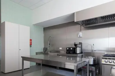 a kitchen with a large stainless steel counter top at Jeugdverblijfcentrum Schotte in Aalst