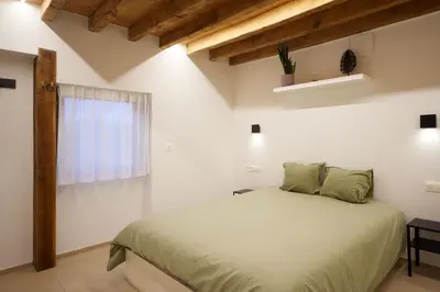 a bedroom with a bed and a window at Het Molenhuisje in Brecht