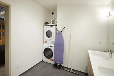 a washing machine sitting next to a dryer in a room at Het Molenhuisje in Brecht