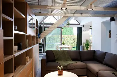 a living room with a couch and a table at Het Molenhuisje in Brecht