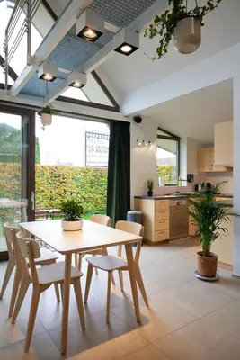 a kitchen and dining room with a table and chairs at Het Molenhuisje in Brecht