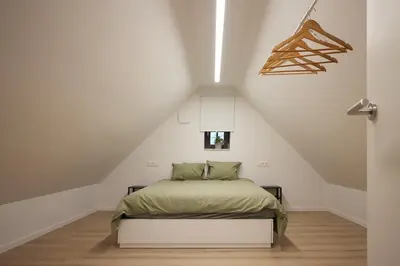 a bedroom with a bed in a attic at Het Molenhuisje in Brecht