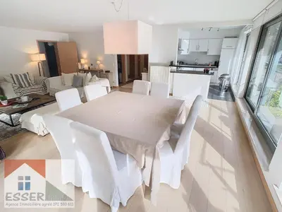 a dining room with a white table and white chairs at Appartement 120m2 plus terrasse in Brussels
