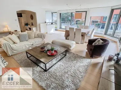 a living room with a couch and a table at Appartement 120m2 plus terrasse in Brussels