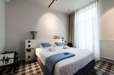 a bedroom with a large bed and a window at Studio Retreat in the Centre of Ghent in Ghent