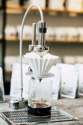 a coffee maker sitting on a table with a glass at Studio Retreat in the Centre of Ghent in Ghent