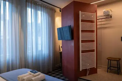 a room with a bed and a tv and a window at Studio Retreat in the Centre of Ghent in Ghent