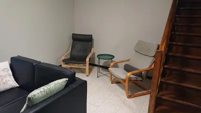 a living room with two chairs and a couch at Tregadata guesthouse in Overijse