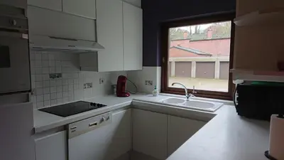 a small kitchen with a sink and a window at Tregadata guesthouse in Overijse