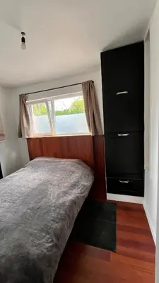 a small bedroom with a bed and a window at Casa Mellow in Ghent