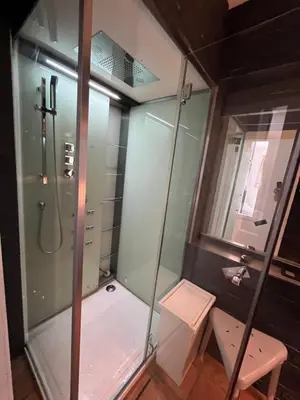 a shower with a glass door in a bathroom at Casa Mellow in Ghent