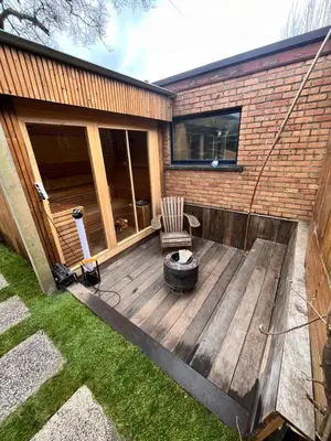 a wooden deck with a chair on a house at Casa Mellow in Ghent