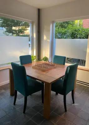 a dining room table with a chess board on it at Casa Mellow in Ghent
