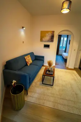 a living room with a blue couch and a table at Brussels City Center Oasis in Brussels