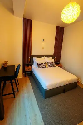 a bedroom with a bed and a table and a desk at Brussels City Center Oasis in Brussels