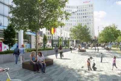 a group of people sitting on benches in a plaza at Brussels City Center Oasis in Brussels