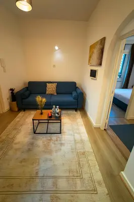 a living room with a blue couch and a table at Brussels City Center Oasis in Brussels