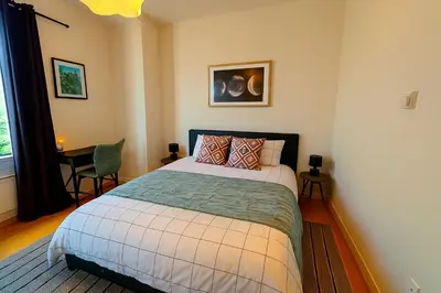 a bedroom with a bed and a table and a window at Brussels Central City Oasis in Brussels